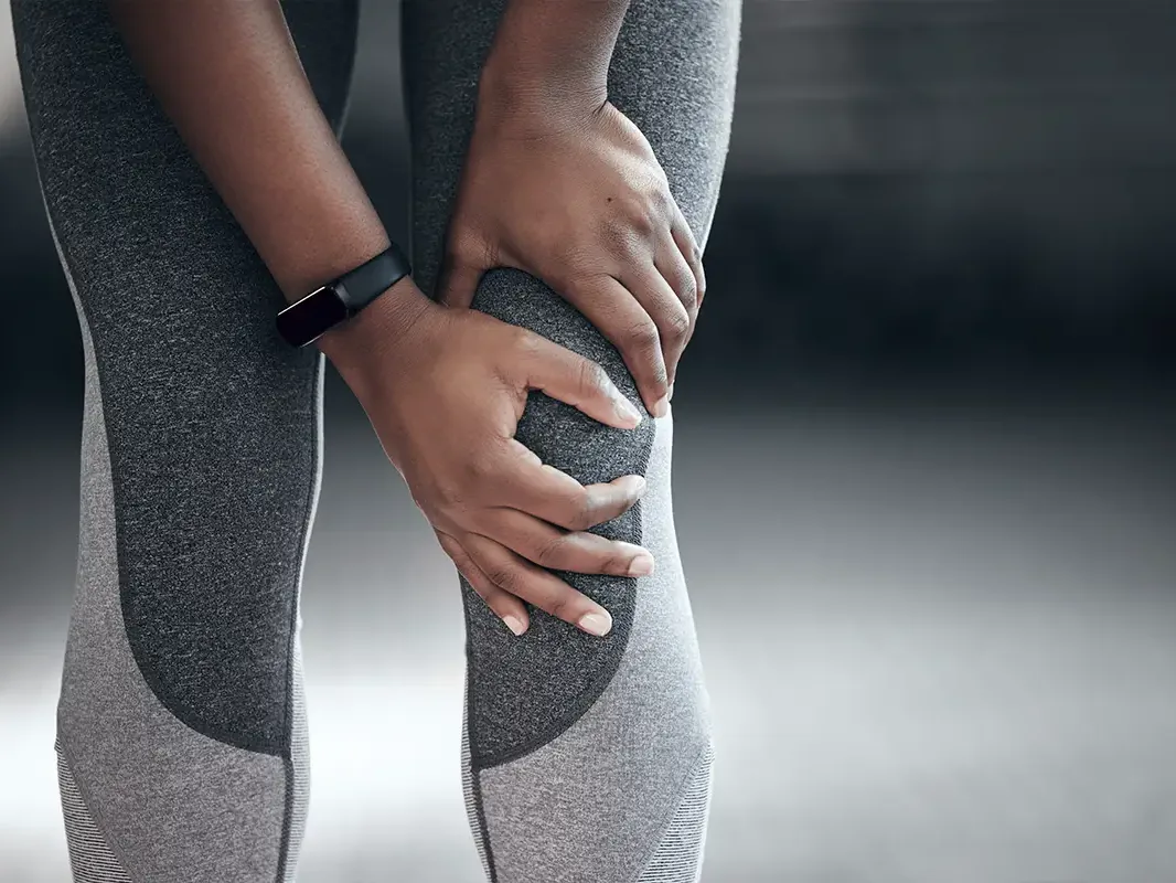 Person holding a sore knee