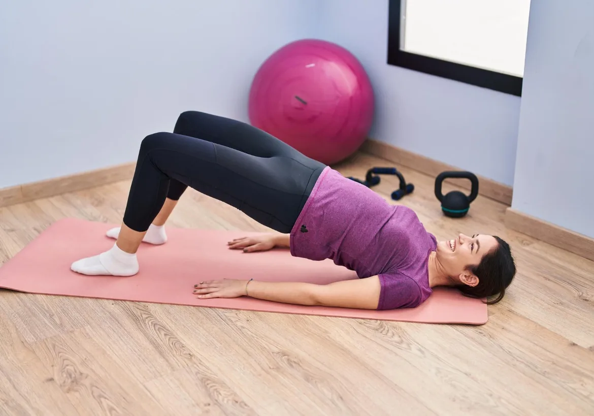 Woman doing a bridge exercise on a mat