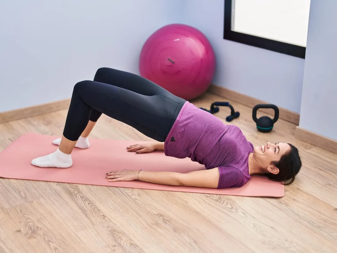 Woman doing a bridge exercise on a mat