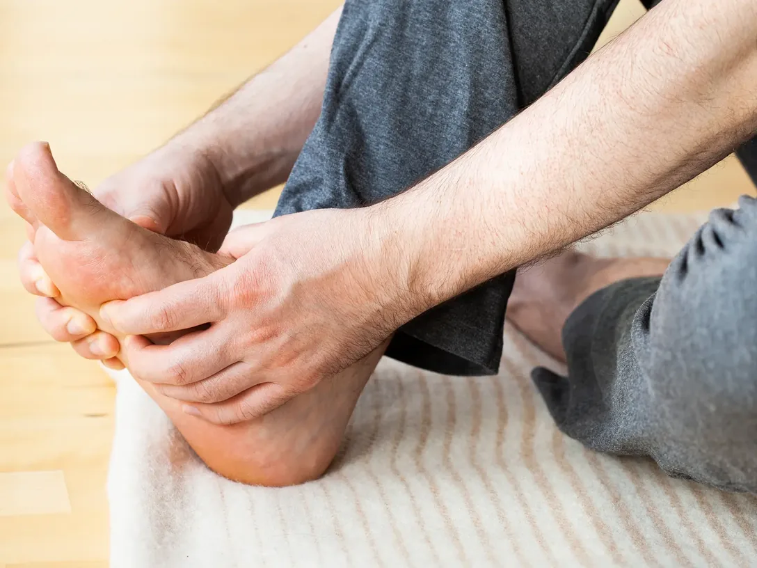 Hands massaging the sole of a foot