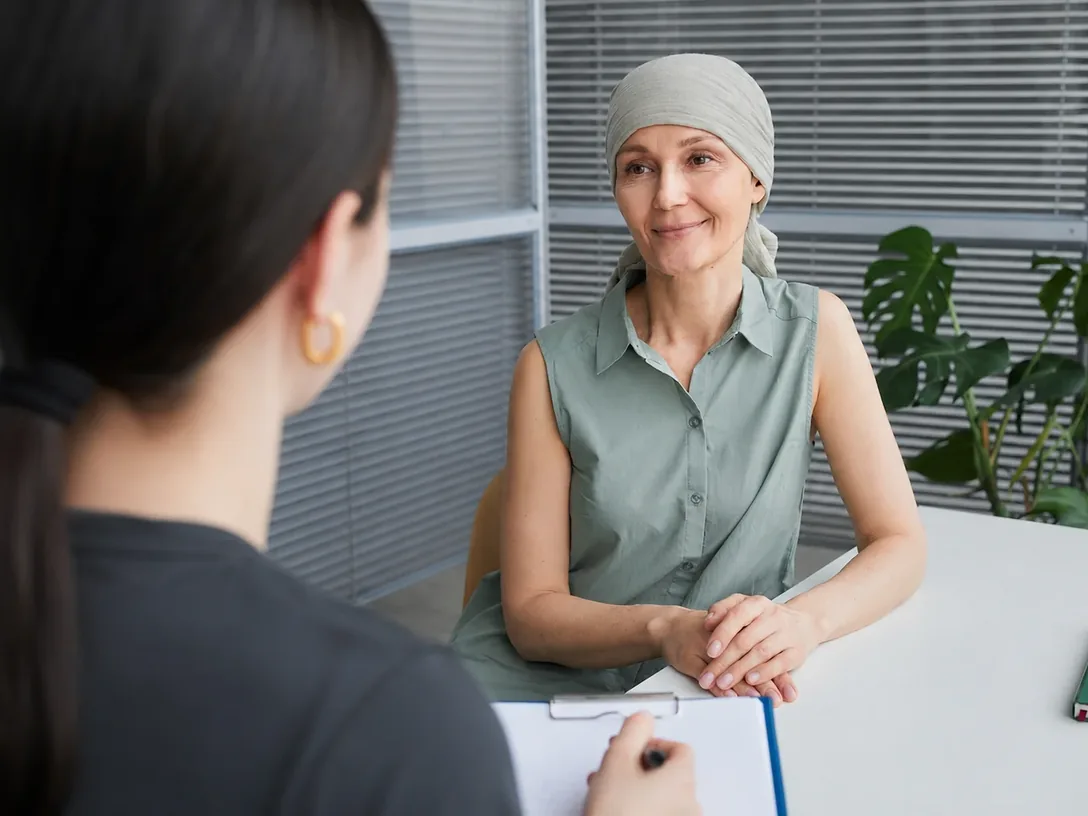 Woman in a headscarf talking with a clinician