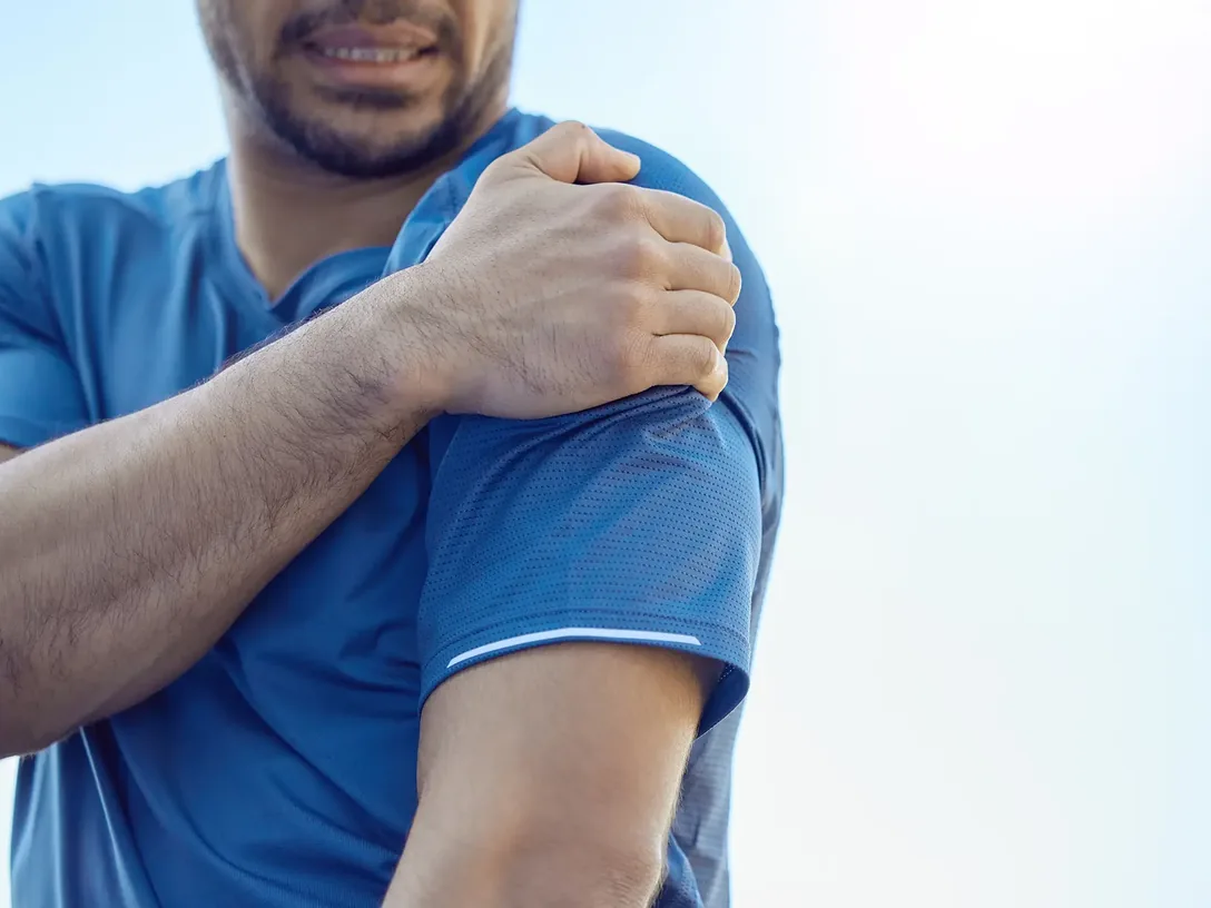 Man holding his sore shoulder