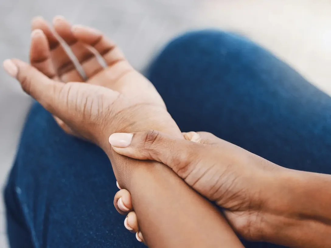 Person holding a sore wrist
