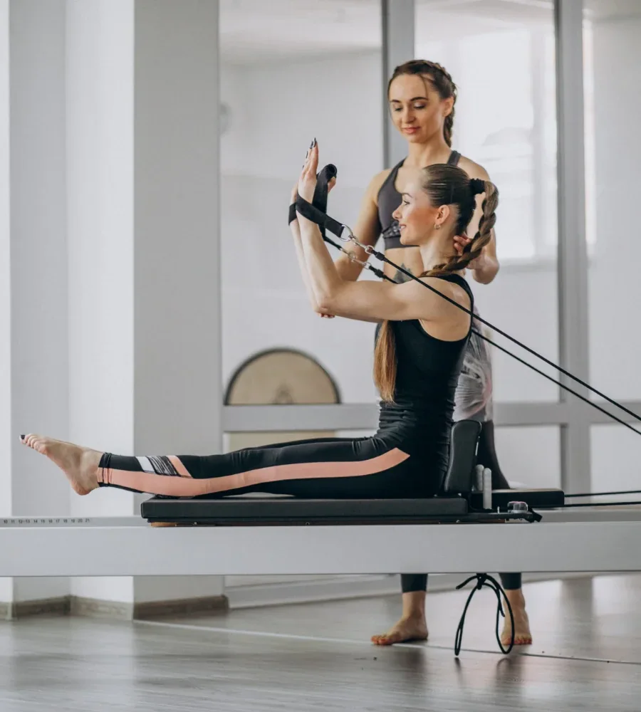 Woman exercising on a Pilates reformer
